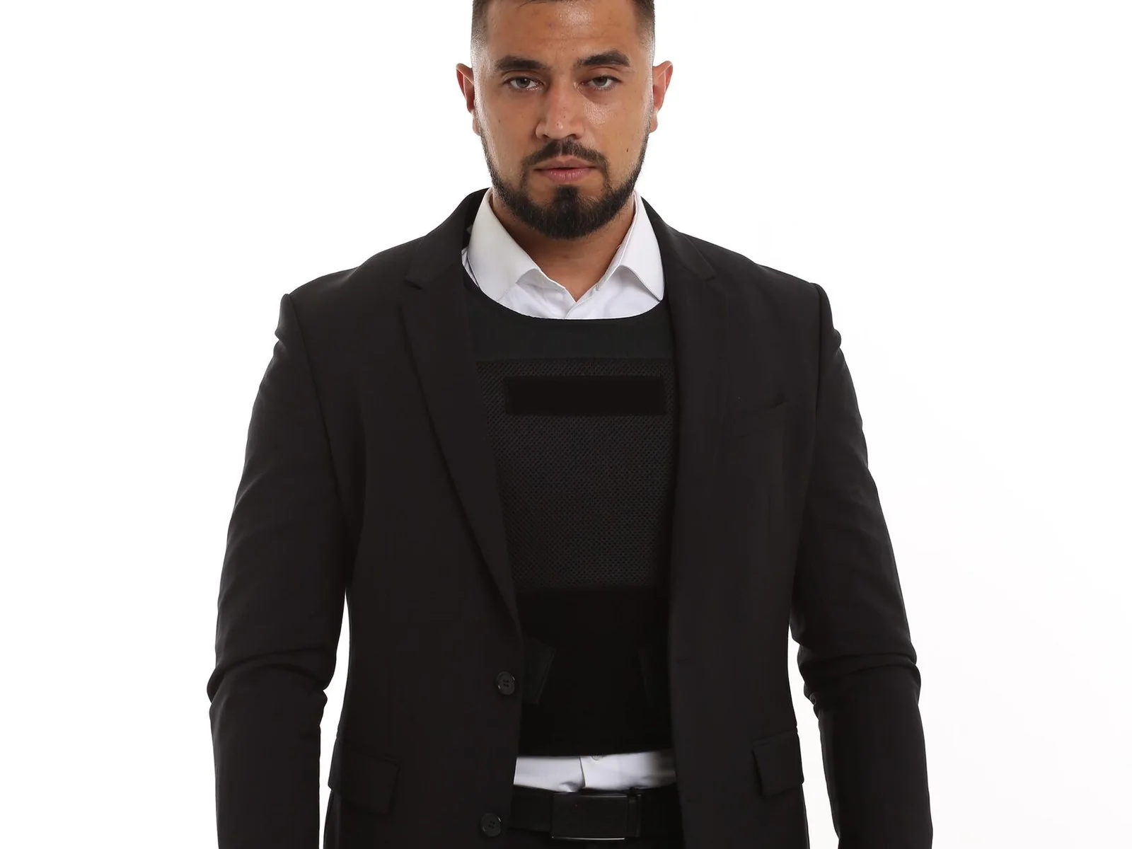 COYOTE Br1 concealable body armor under an unbuttoned suit jacket